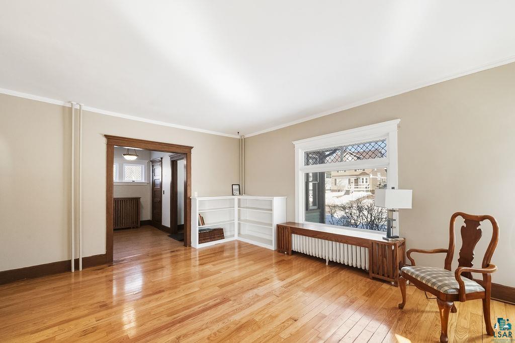 4220 McCulloch Street Duluth, MN 55804 - Photo 3 of 27 Sitting room with light wood finished floors, ornamental molding, and radiator heating unit