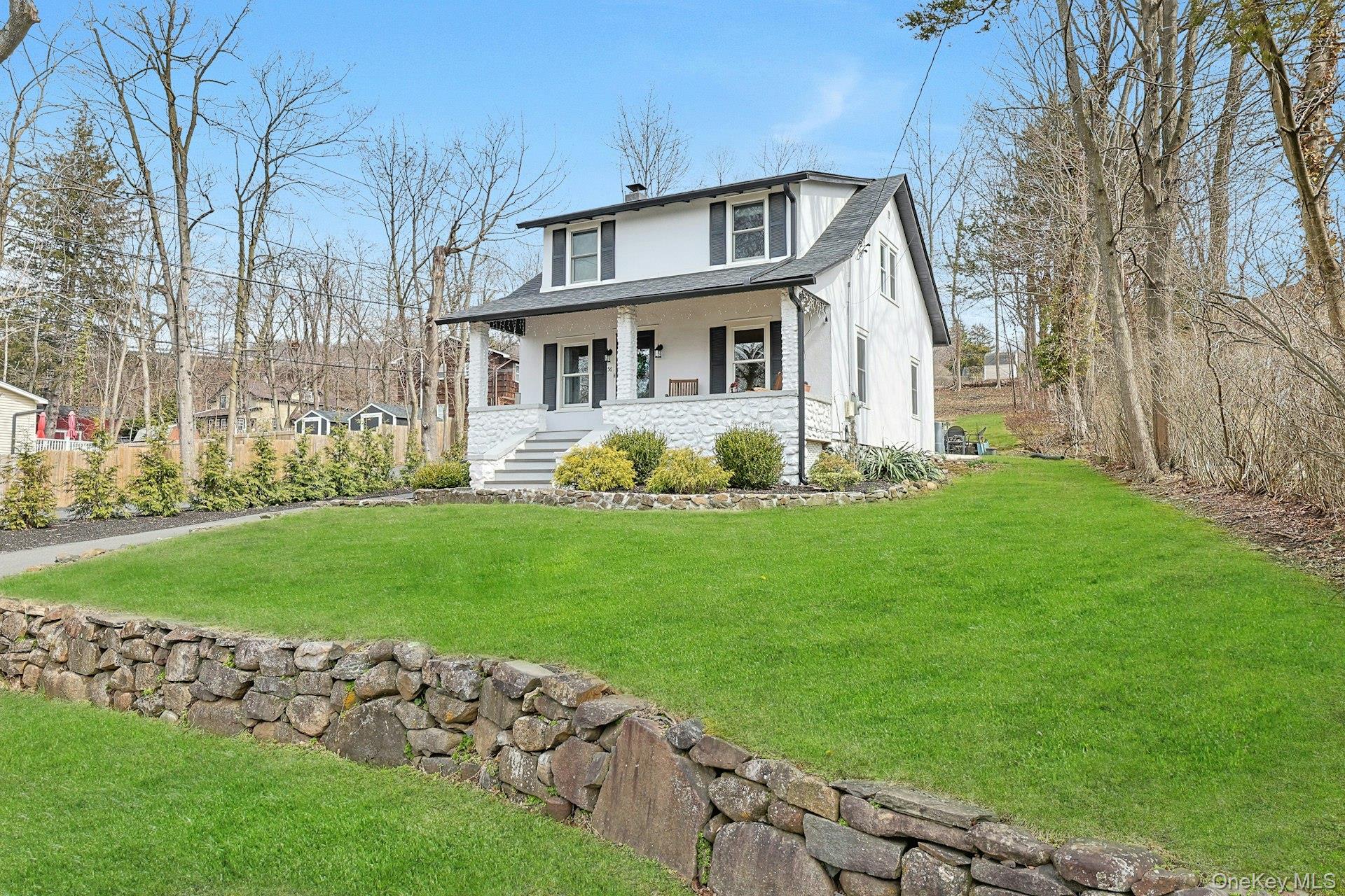 56 North Greenbush Road West Nyack, NY 10994 - Photo 1 of 37 a front view of a house with a garden and trees