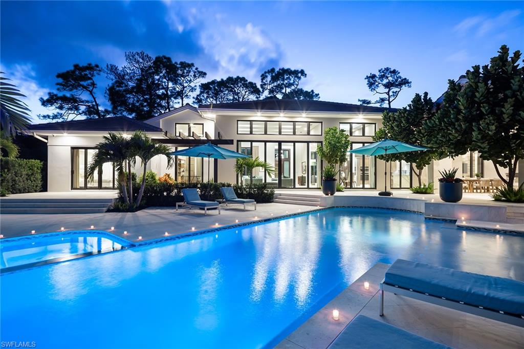 494 Gordonia Road Naples, FL 34108 - Photo 1 of 42 a view of a swimming pool with an outdoor seating