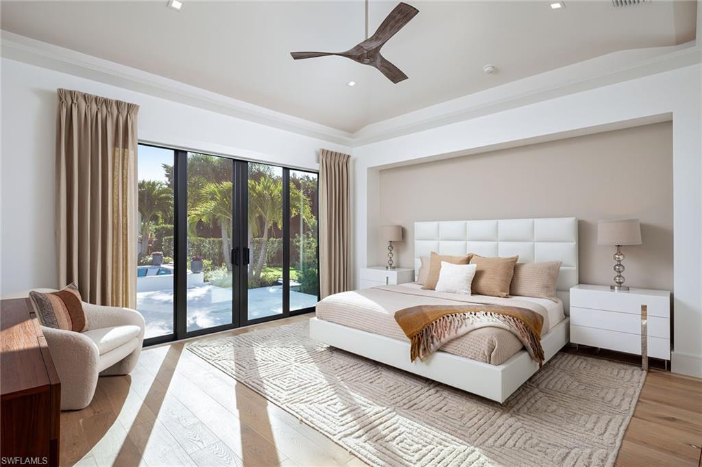 494 Gordonia Road Naples, FL 34108 - Photo 11 of 42 a bedroom with a bed and a couch