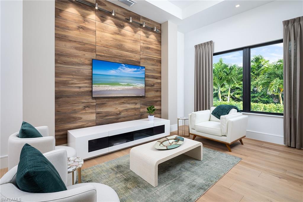 494 Gordonia Road Naples, FL 34108 - Photo 16 of 42 a living room with furniture and a large window