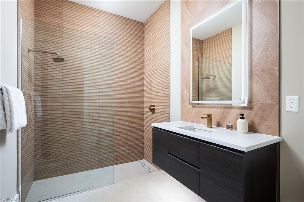 494 Gordonia Road Naples, FL 34108 - Photo 20 of 42 a bathroom with a sink and a mirror