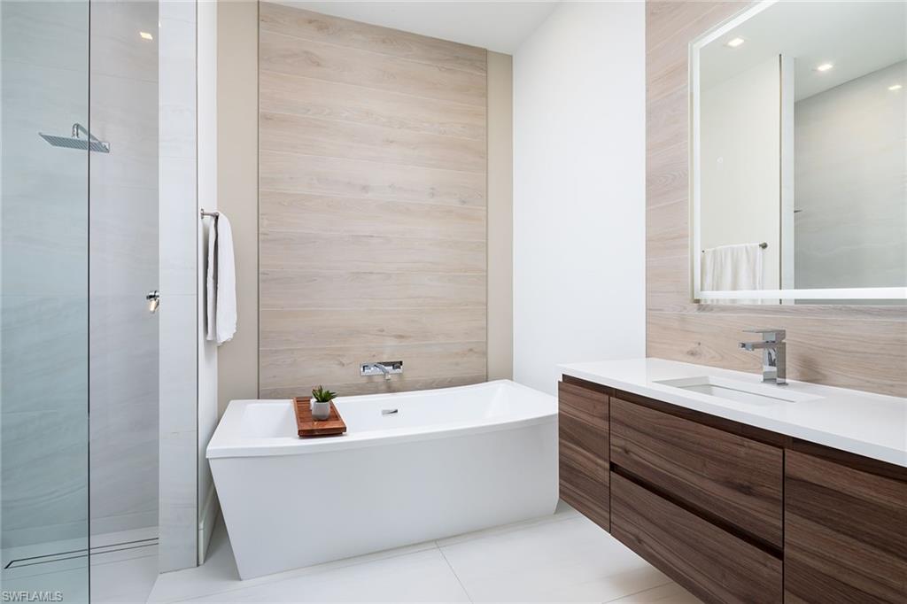 494 Gordonia Road Naples, FL 34108 - Photo 22 of 42 a bathroom with a bathtub and a sink
