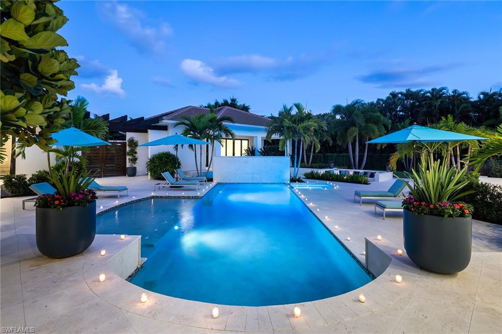 494 Gordonia Road Naples, FL 34108 - Photo 33 of 42 a view of a swimming pool with a patio