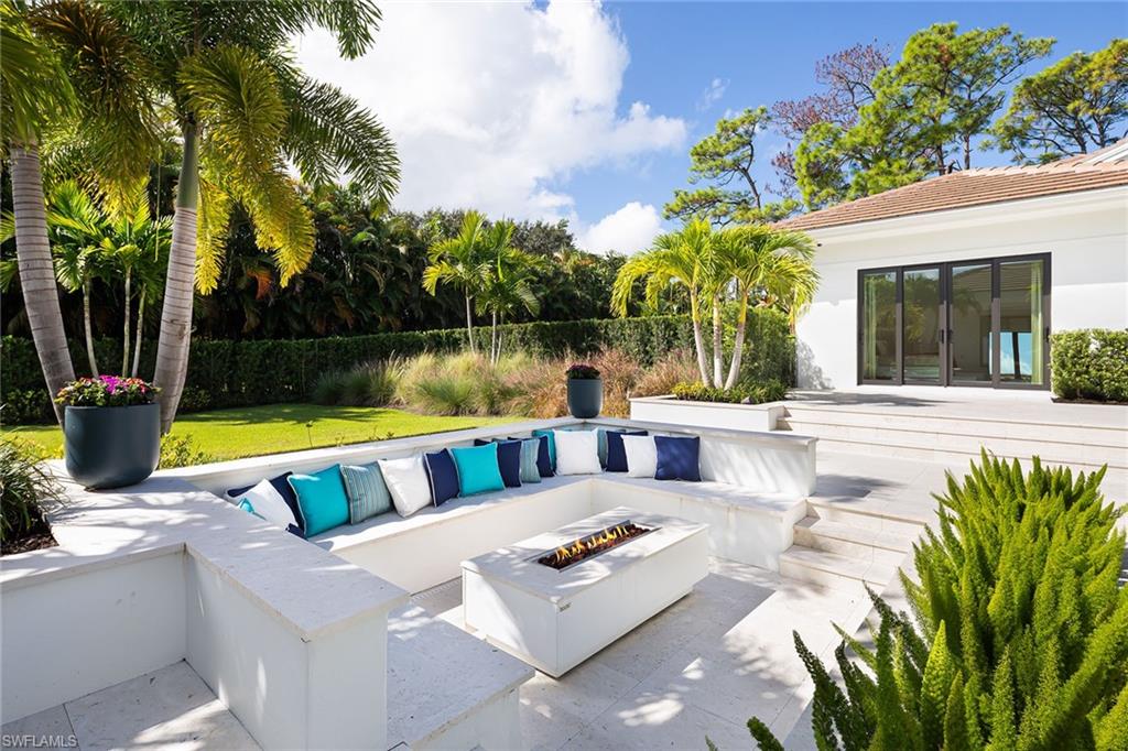 494 Gordonia Road Naples, FL 34108 - Photo 36 of 42 a view of swimming pool with outdoor seating and yard