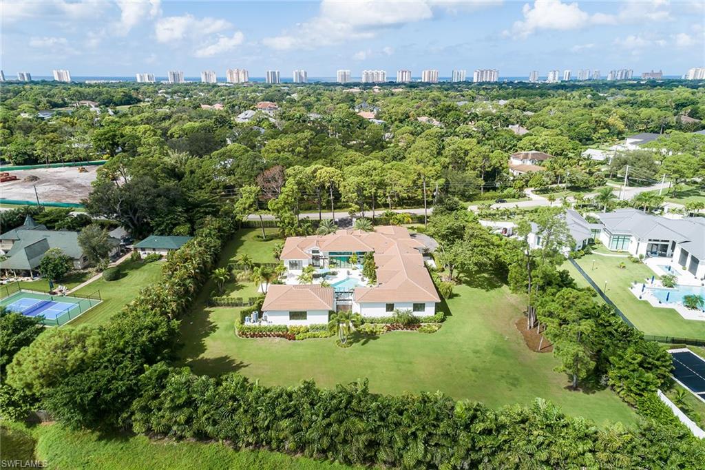 494 Gordonia Road Naples, FL 34108 - Photo 39 of 42 an aerial view of a house with a yard and lake view