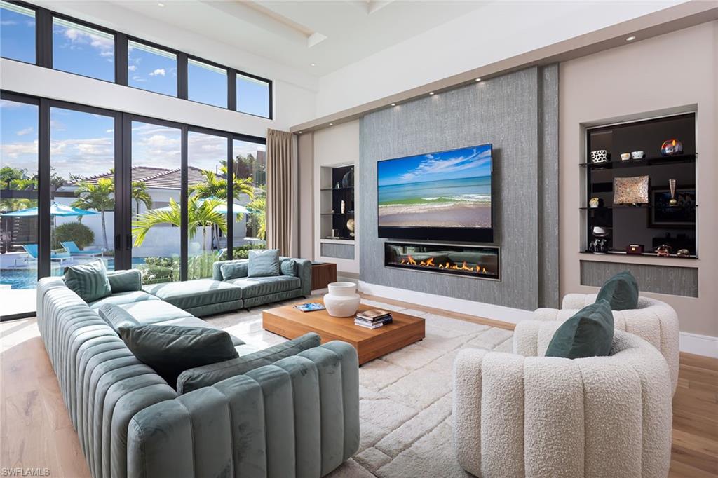 494 Gordonia Road Naples, FL 34108 - Photo 4 of 42 a living room with furniture and a flat screen tv