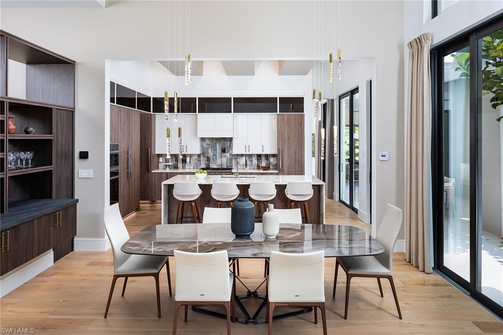 494 Gordonia Road Naples, FL 34108 - Photo 6 of 42 a view of a dining room with furniture and window