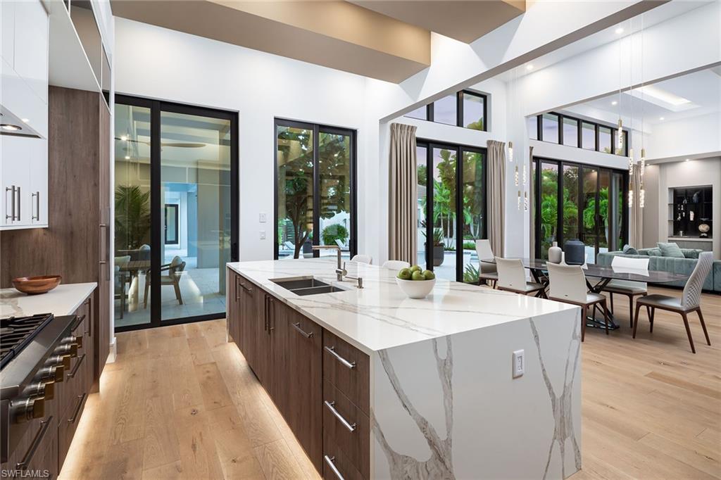 494 Gordonia Road Naples, FL 34108 - Photo 8 of 42 a large white kitchen with a large window
