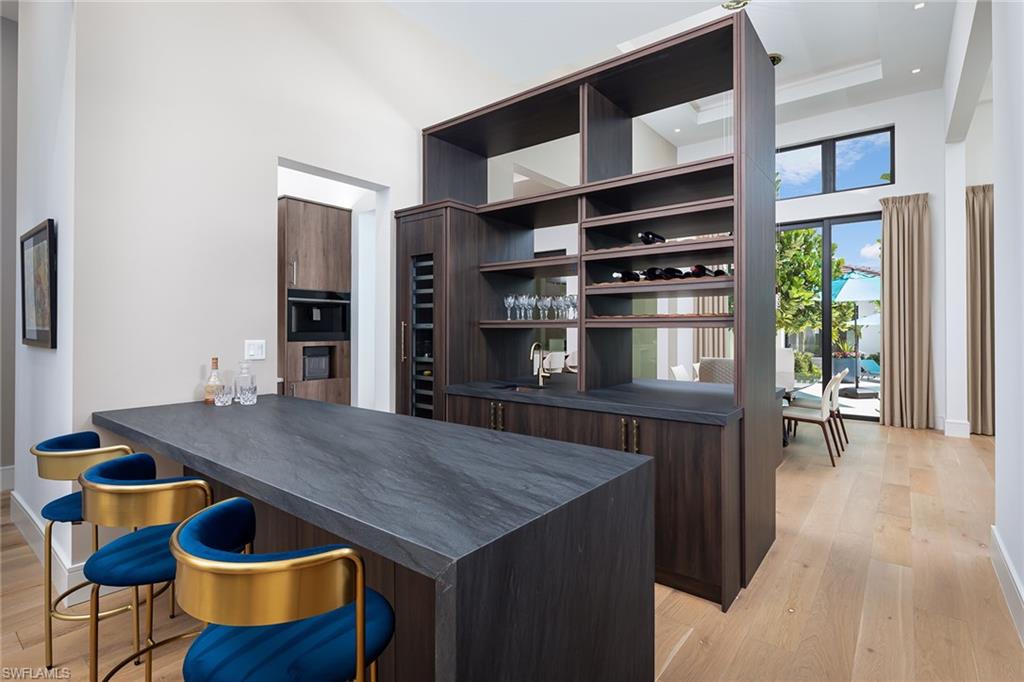 494 Gordonia Road Naples, FL 34108 - Photo 9 of 42 a kitchen with a table and chairs