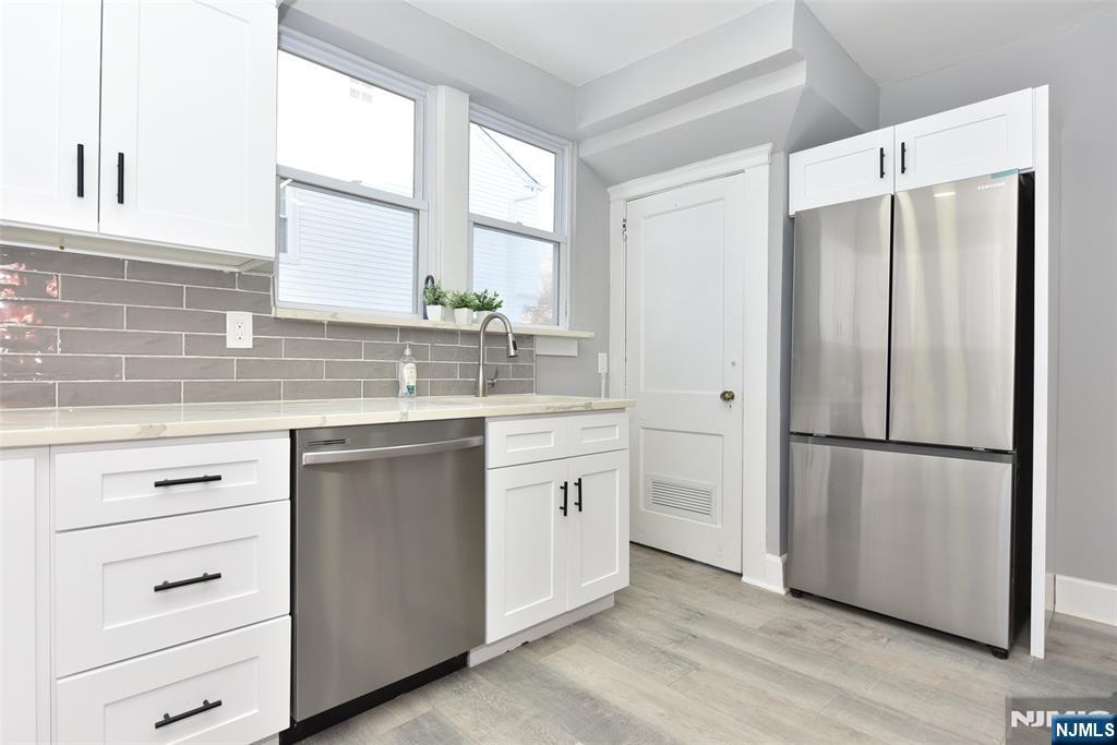 228 Ridgefield Avenue Bogota, NJ 07603 - Photo 13 of 29 a kitchen with white cabinets and white appliances
