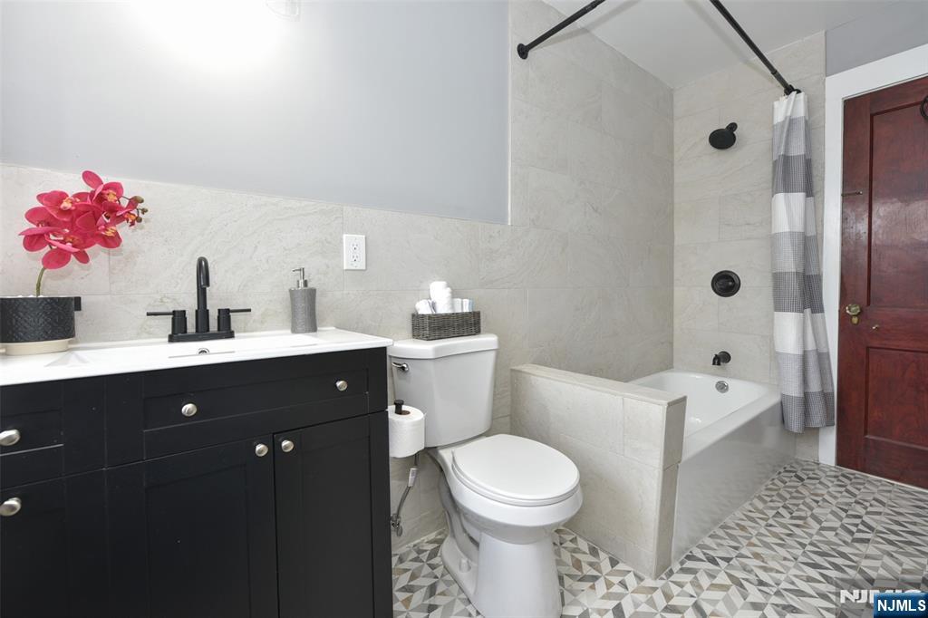 228 Ridgefield Avenue Bogota, NJ 07603 - Photo 21 of 29 a bathroom with a sink a toilet and shower