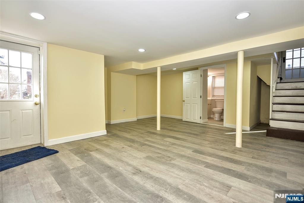 228 Ridgefield Avenue Bogota, NJ 07603 - Photo 24 of 29 an empty room with wooden floor and windows
