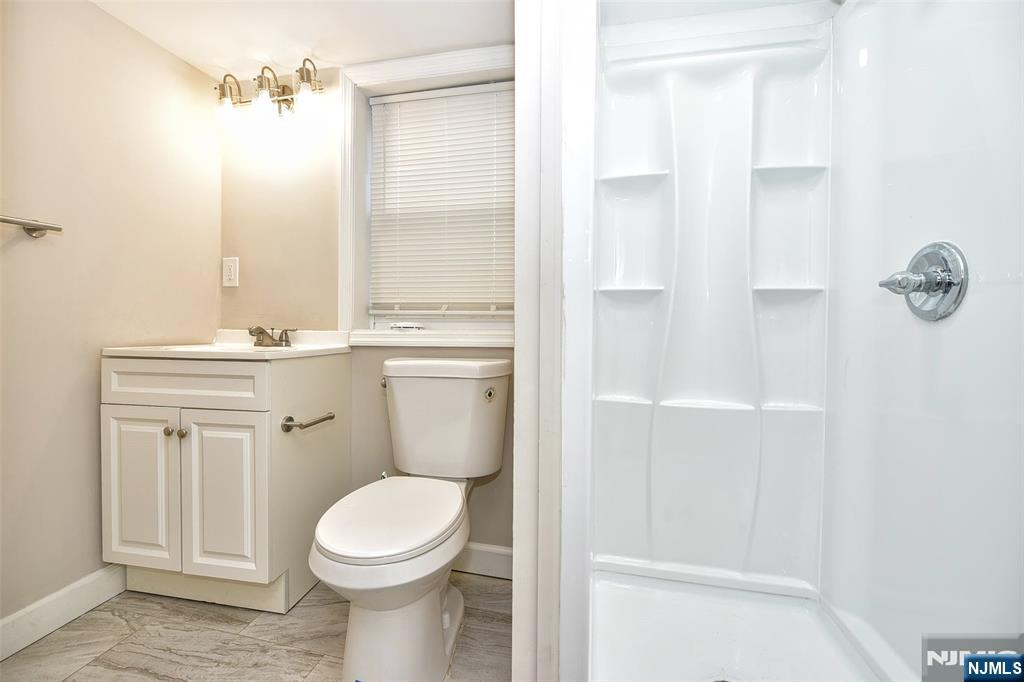228 Ridgefield Avenue Bogota, NJ 07603 - Photo 25 of 29 a bathroom with a toilet a sink and a shower