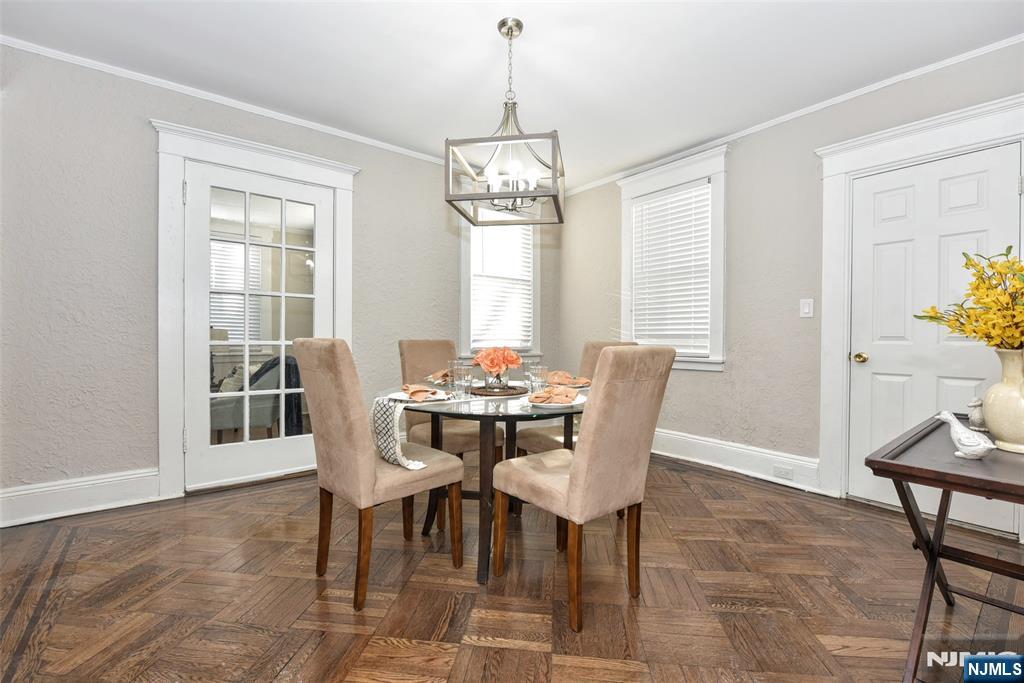 228 Ridgefield Avenue Bogota, NJ 07603 - Photo 8 of 29 a dining room with furniture a chandelier and wooden floor