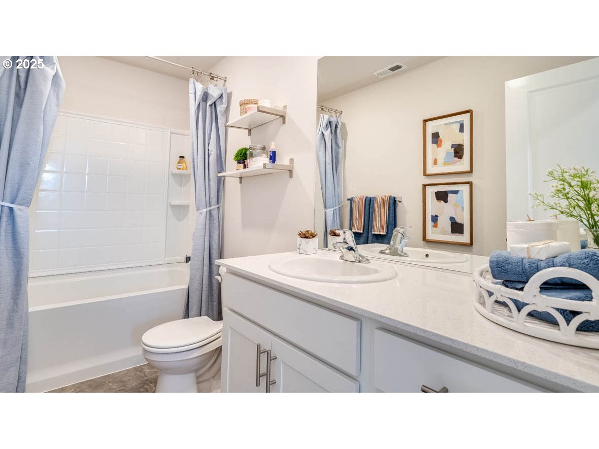 2971 T Street Springfield, OR 97477 - Photo 21 of 30 a bathroom with a sink a toilet and a large mirror