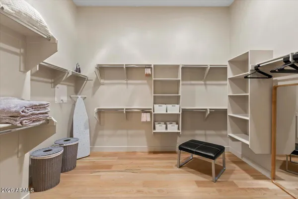 a view of walk in closet with empty racks