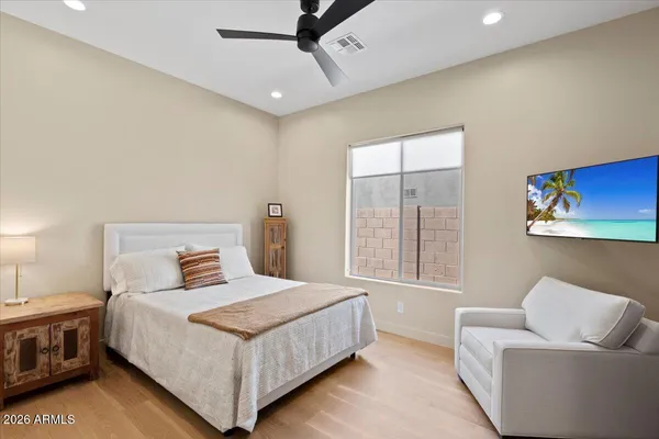 a bedroom with a bed couch and window