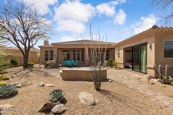 a view of a house with backyard porch and sitting area
