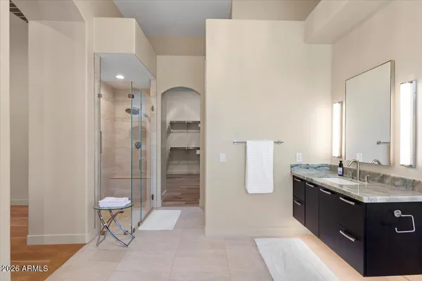 a bathroom with a double vanity sink toilet and shower