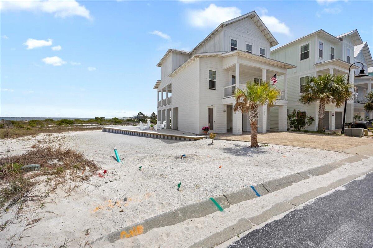 1454 Seaside Circle Navarre, FL 32566 - Photo 14 of 18 a view of a white house with a swimming pool