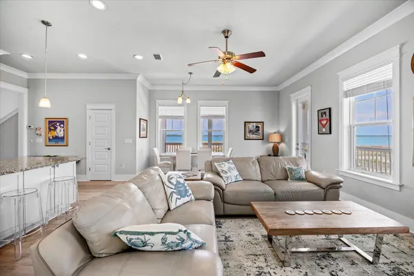 a view of a balcony with chairs and wooden floor