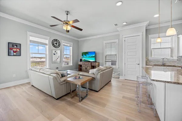 a kitchen with a refrigerator a sink and a stove top oven