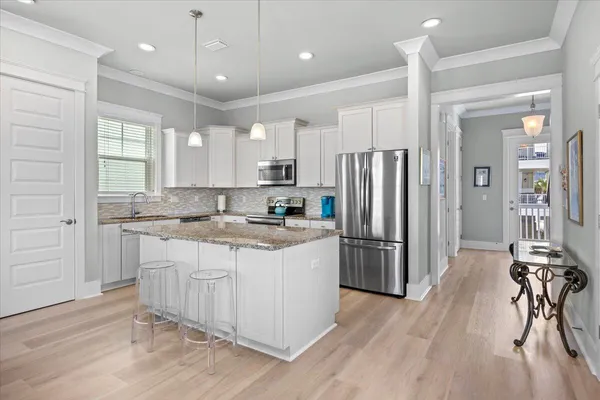 a view of a hallway with wooden floor and entryway