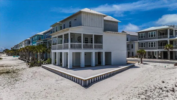 a view of a building with a bench in front of house