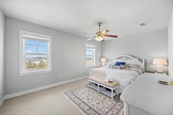 a bedroom with bed and a chandelier