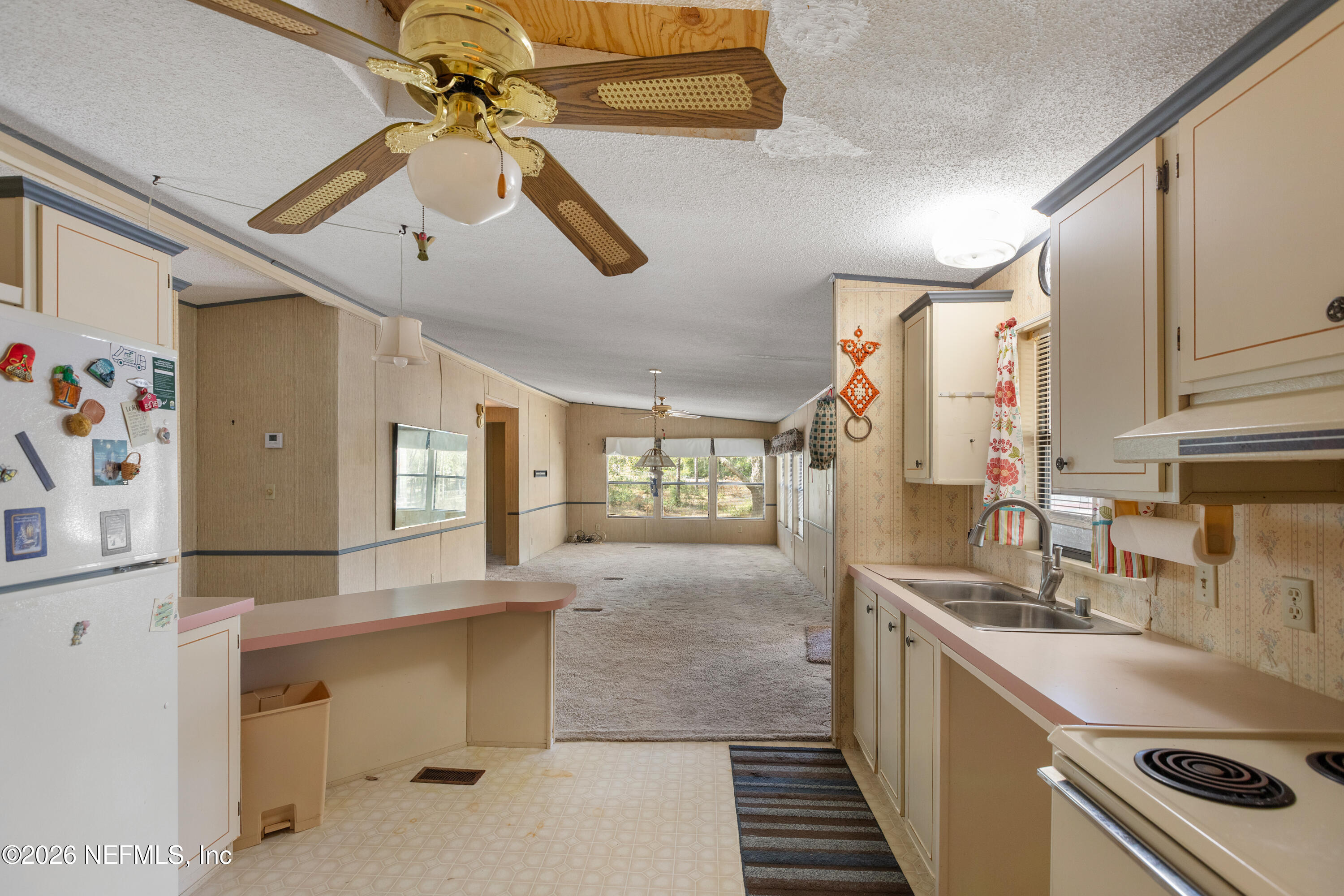 6950 Deer Springs Road Keystone Heights, FL 32656 - Photo 11 of 46 a kitchen with granite countertop a sink a counter space cabinets and stainless steel appliances