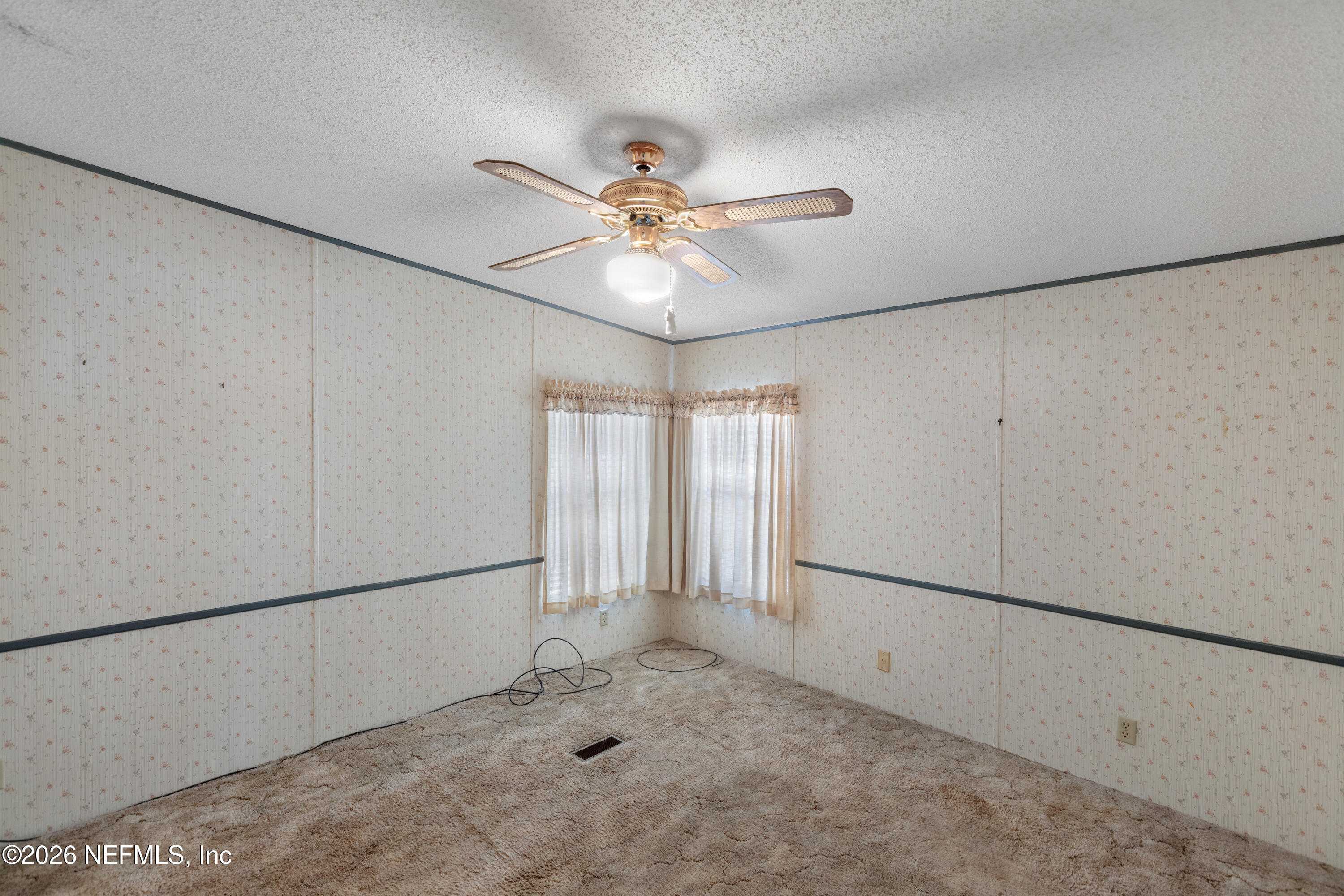 6950 Deer Springs Road Keystone Heights, FL 32656 - Photo 18 of 46 a view of a livingroom with a ceiling fan and window
