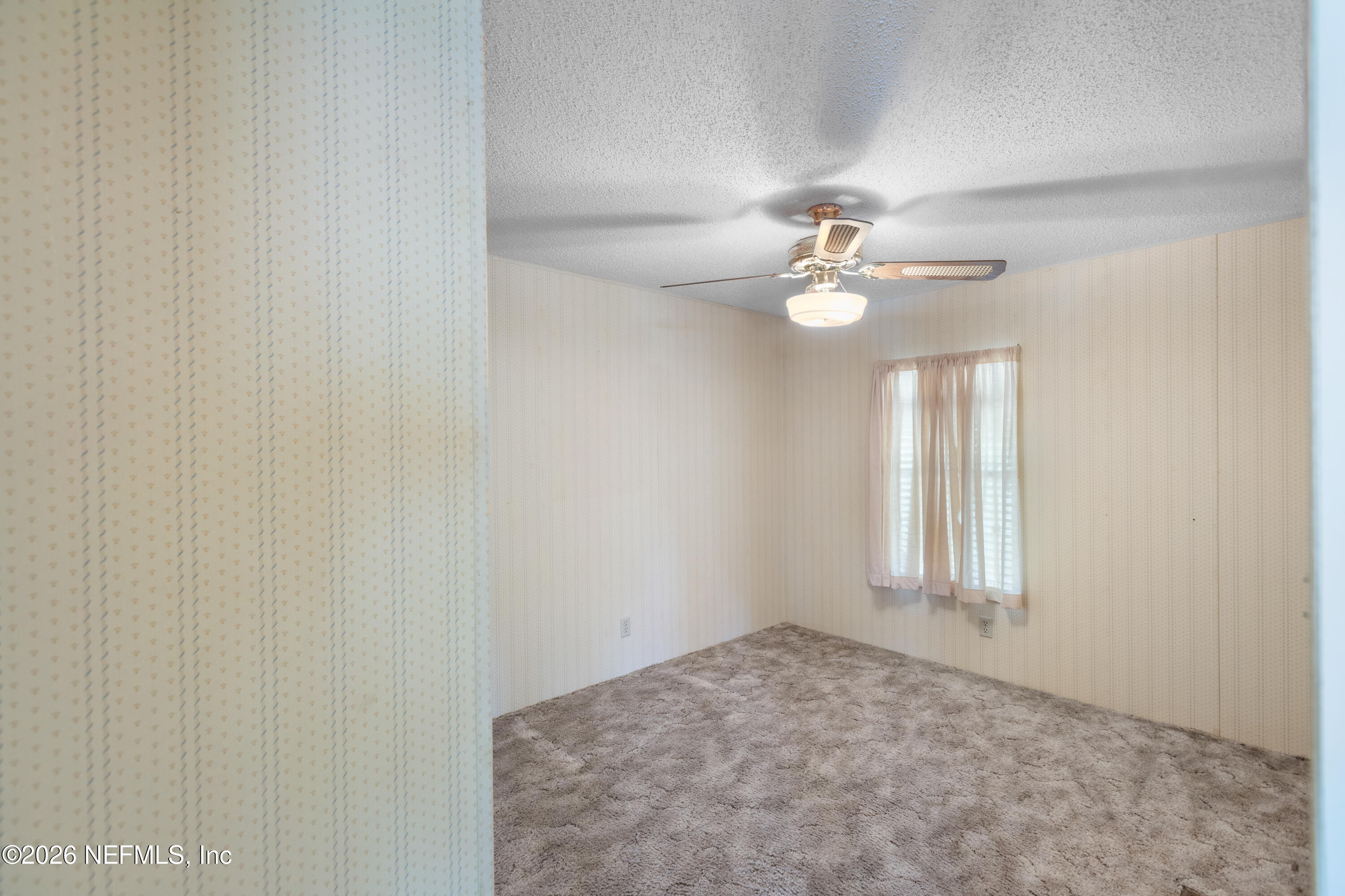 6950 Deer Springs Road Keystone Heights, FL 32656 - Photo 29 of 46 an empty room with windows and ceiling fan