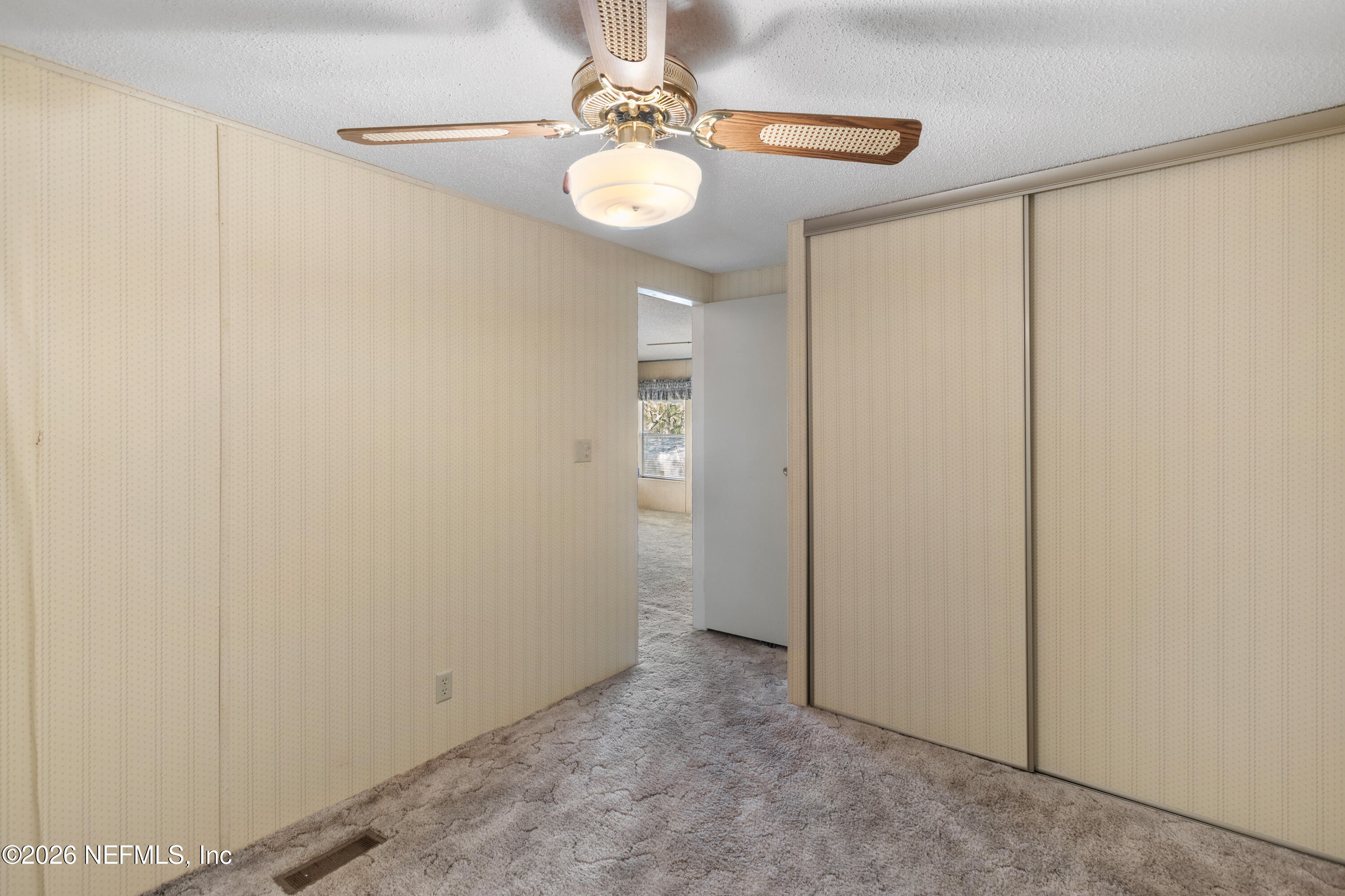 6950 Deer Springs Road Keystone Heights, FL 32656 - Photo 30 of 46 a view of a hallway with chandelier fan