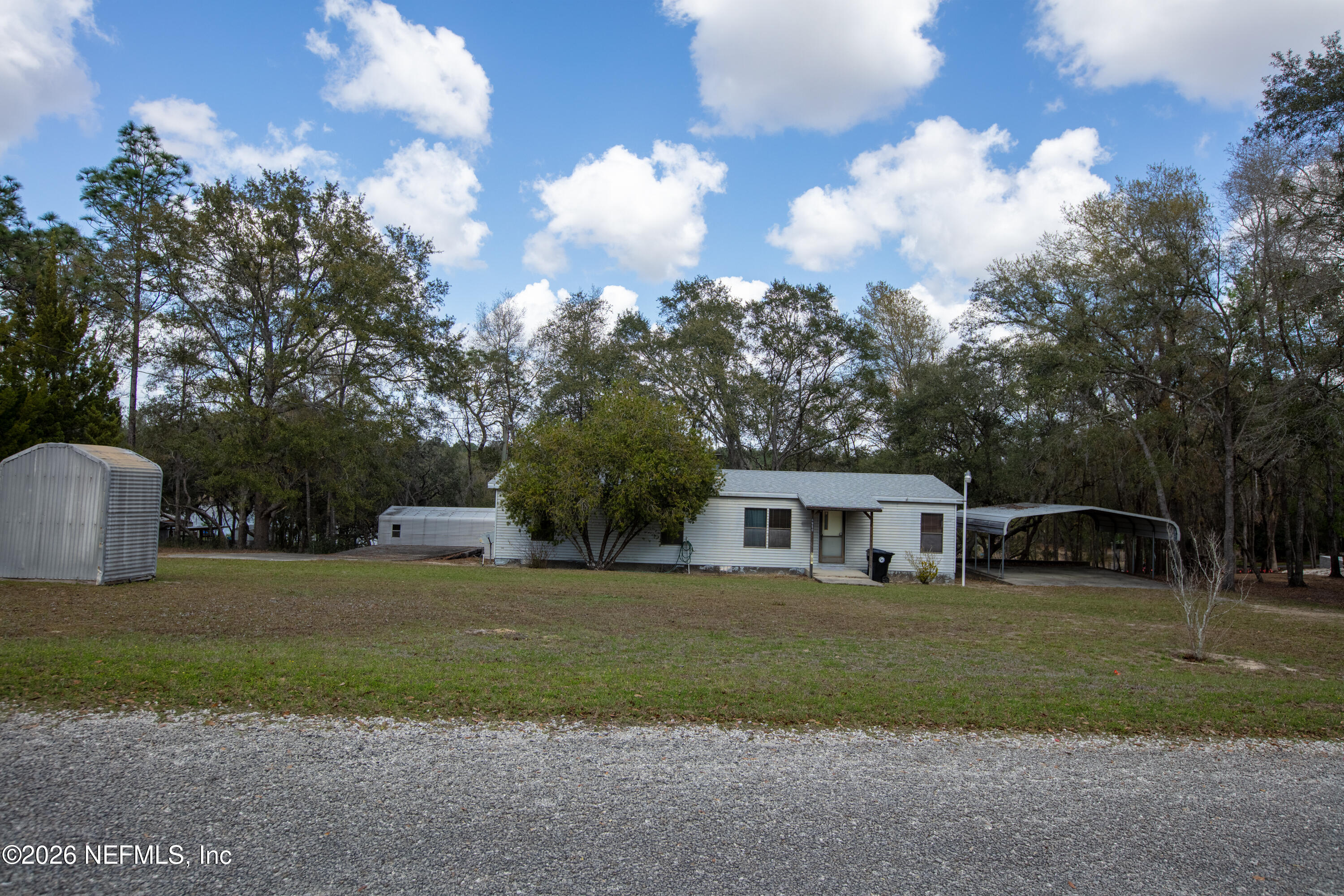 6950 Deer Springs Road Keystone Heights, FL 32656 - Photo 33 of 46 a view of house with a big yard and large trees