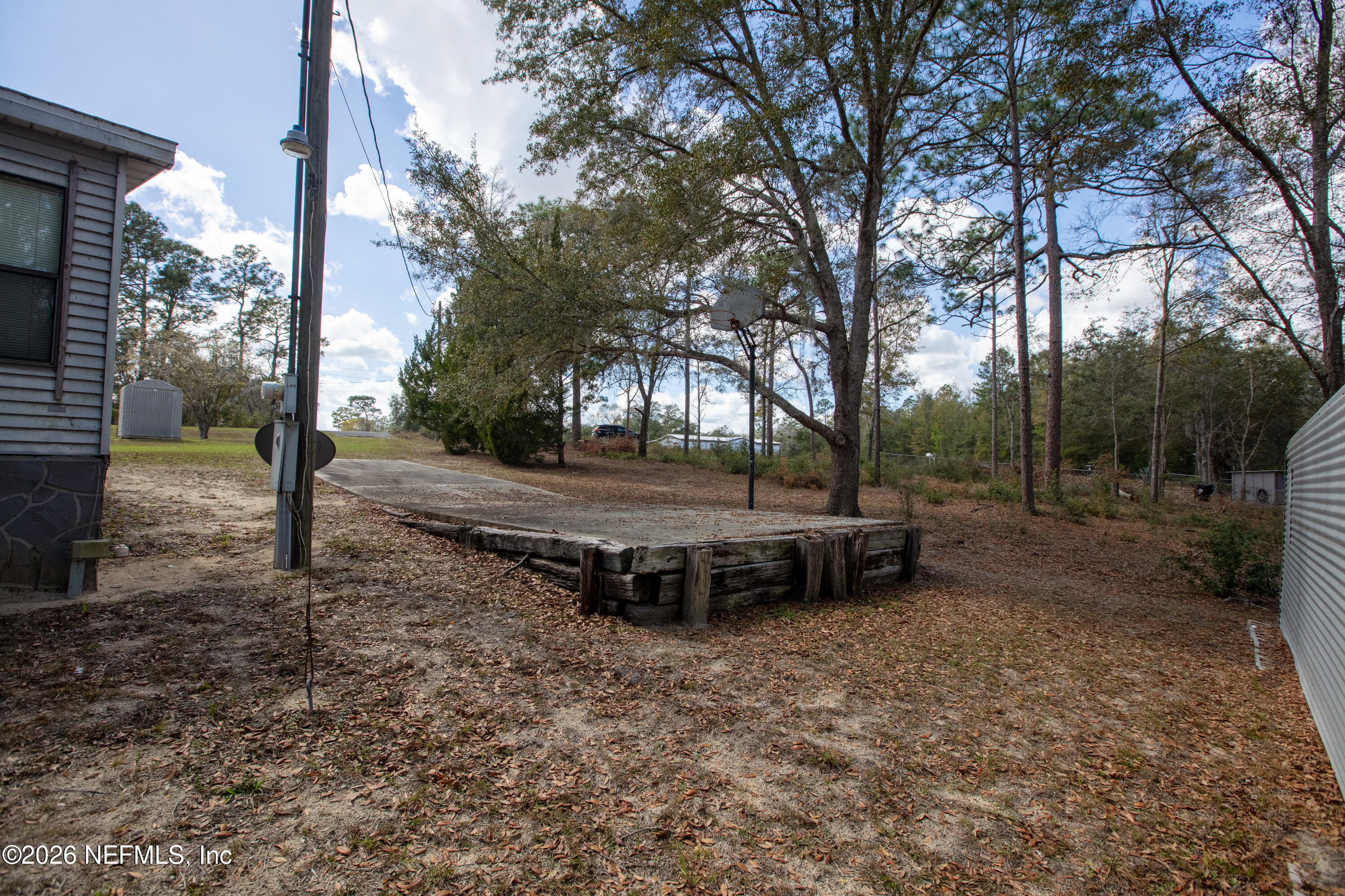 6950 Deer Springs Road Keystone Heights, FL 32656 - Photo 40 of 46 a view of a backyard with large trees