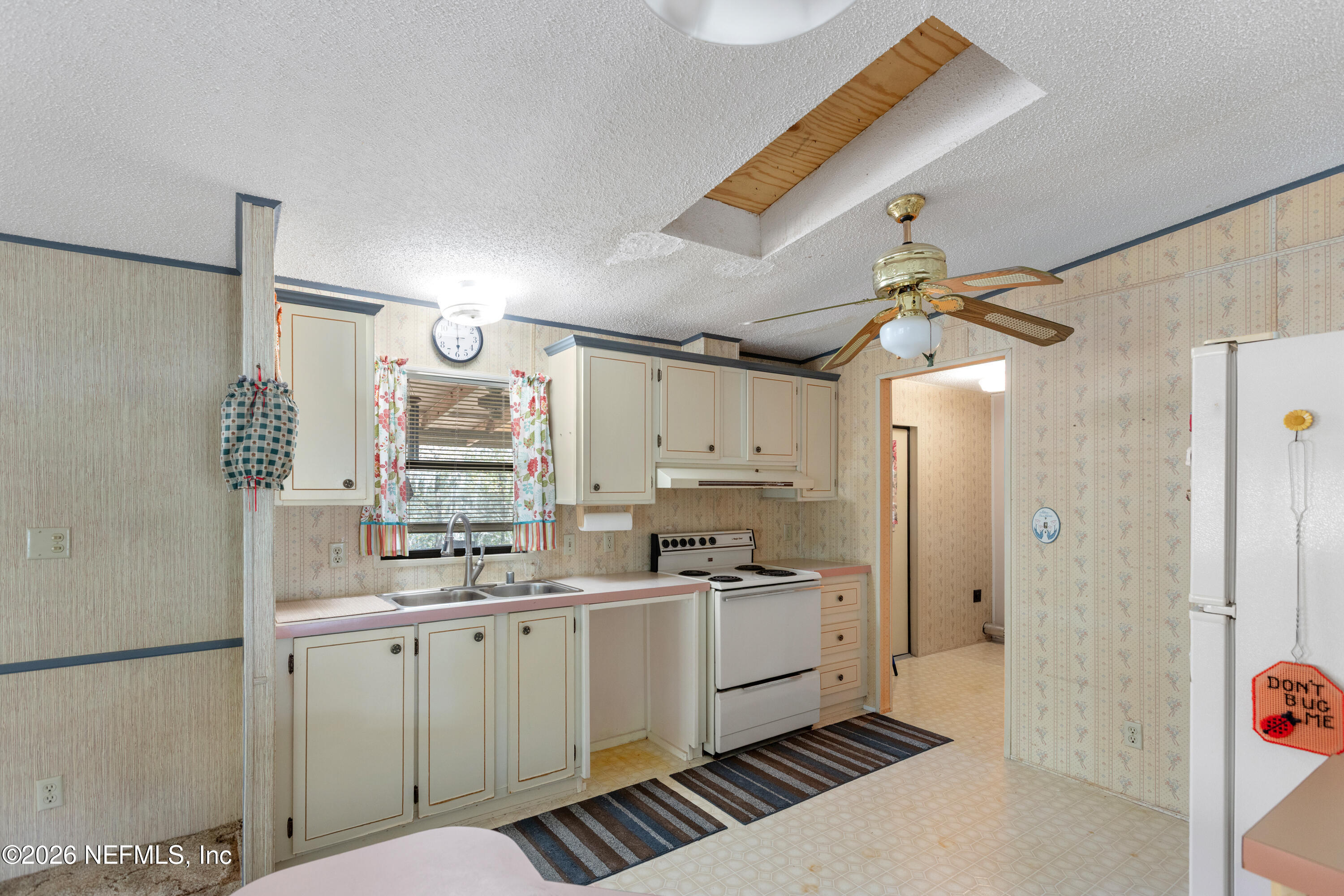 6950 Deer Springs Road Keystone Heights, FL 32656 - Photo 9 of 46 a kitchen with cabinets a sink and appliances