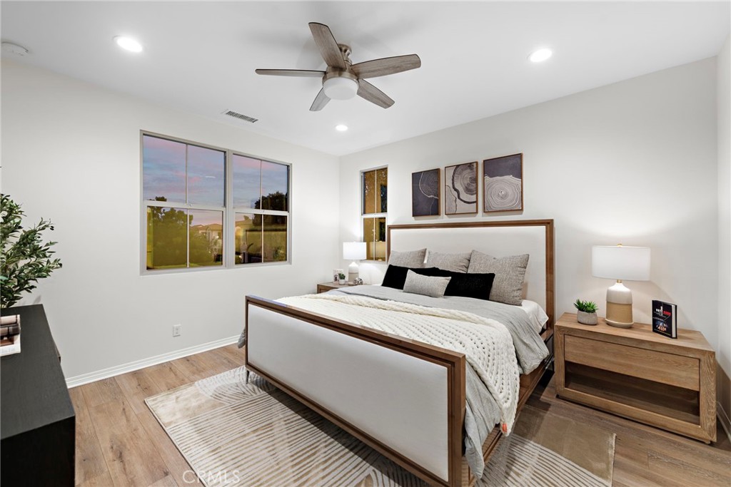 111 Henson Irvine, CA 92620 - Photo 18 of 24 a bedroom with a large bed a chandelier and dresser