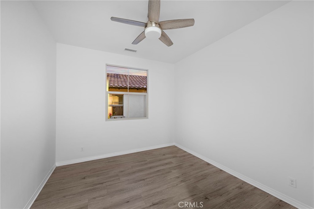111 Henson Irvine, CA 92620 - Photo 22 of 24 a view of an empty room with wooden floor and a window