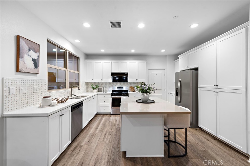 111 Henson Irvine, CA 92620 - Photo 9 of 24 a kitchen with stainless steel appliances granite countertop a sink stove and refrigerator