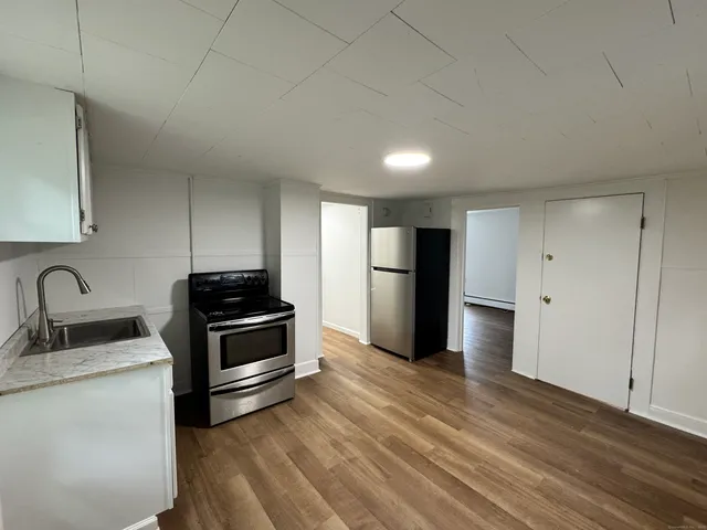 a kitchen with a refrigerator and a sink