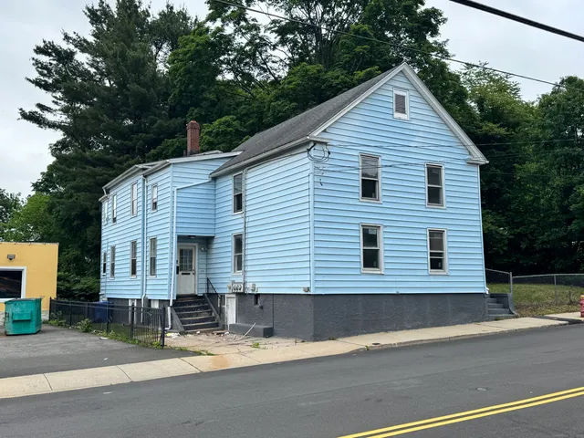 a view of a house with a yard and garage