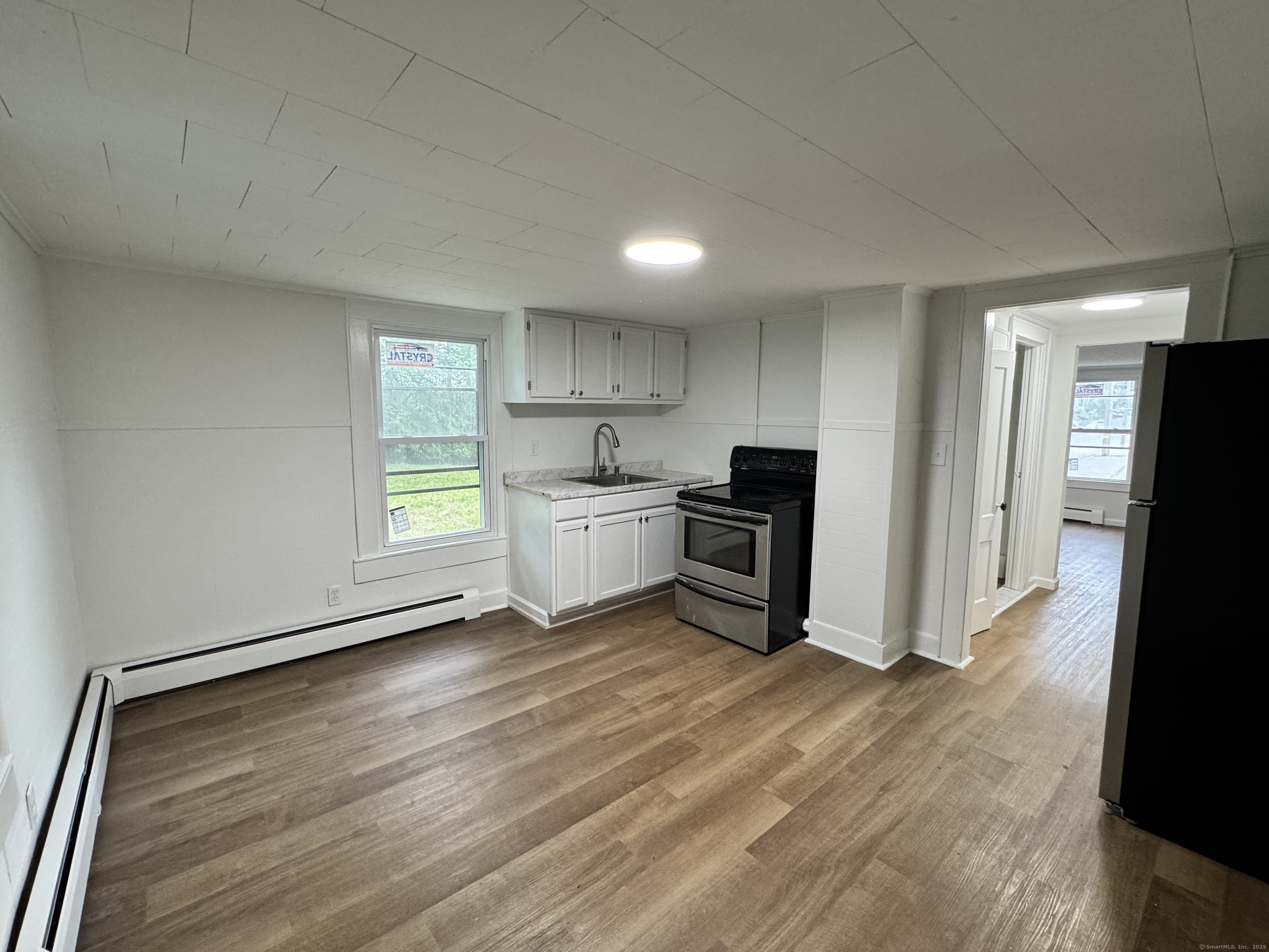 81 Springdale Avenue, Unit 2 Meriden, CT 06451 - Photo 2 of 19 a kitchen with stainless steel appliances a refrigerator and wooden floor