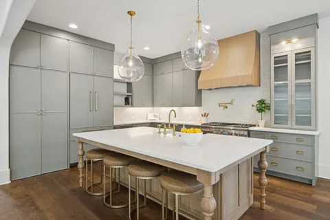 a dining room with furniture a chandelier and wooden floor