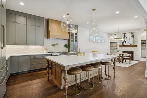 a large bathroom with double vanity sinks a large mirror and a shower