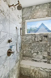 a picture of a room with a bench and a white wall