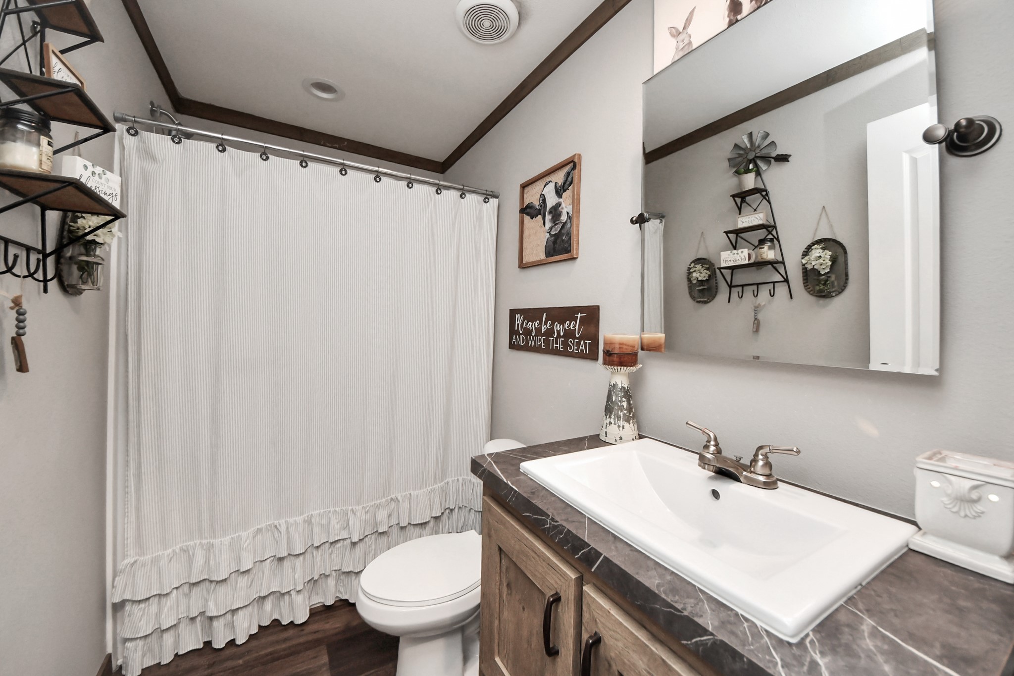 131 Kiowa Court Rosharon, TX 77583 - Photo 27 of 42 This bathroom features a modern vanity with a beautiful countertop, a white sink, bronze fixtures, and a large tub.