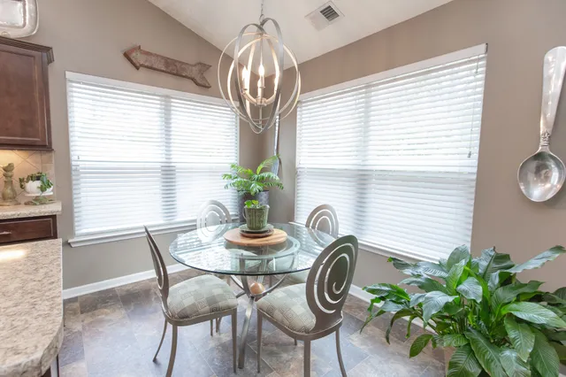 a dining room with furniture and wooden floor