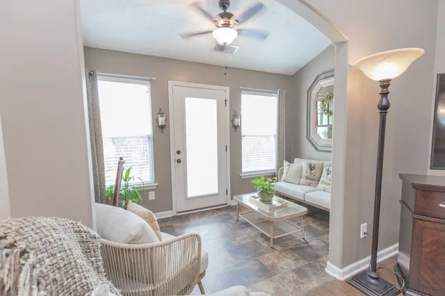a living room with furniture and a large window