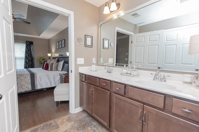 a en suite bathroom with a double vanity sink and a mirror